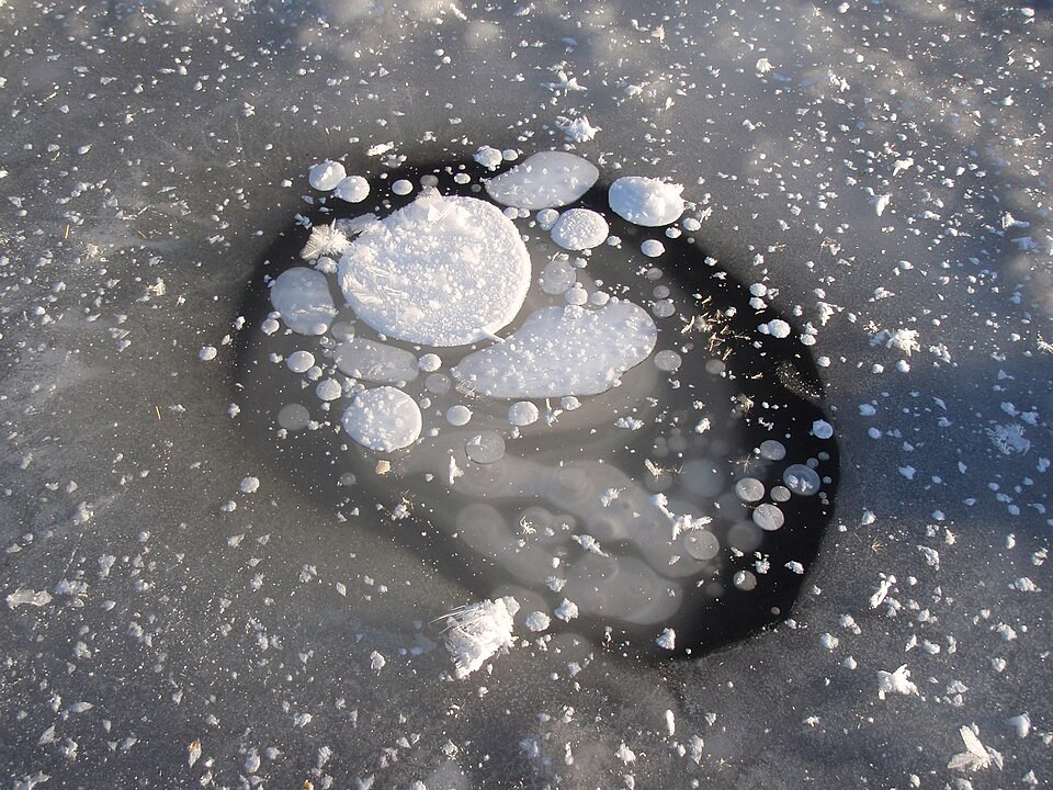 frozen methane bubbles on a lake
